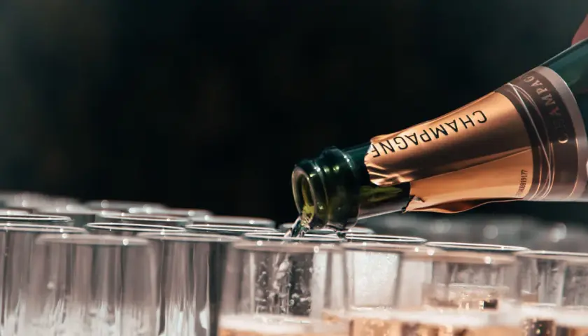 Versando champagne, un brindisi alle migliori annate. Bollicine dorate riempiono i calici in attesa.