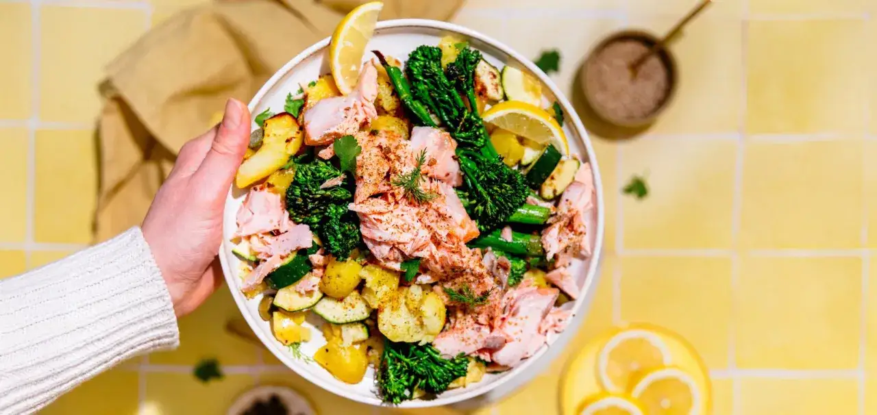 Piatto colorato con salmone sfilettato, patate arrosto, broccoli e zucchine. Un'idea perfetta su cosa abbinare al salmone per un pasto sano e gustoso.